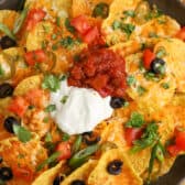 a plate of air fryer nachos with sour cream