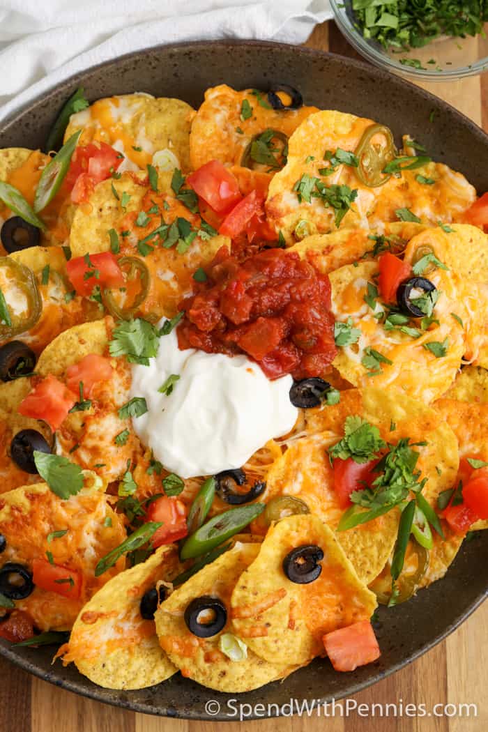 Air Fryer nachos on a plate with sour cream
