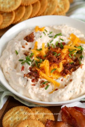 Crack dip in a bowl with cheese bacon and chives