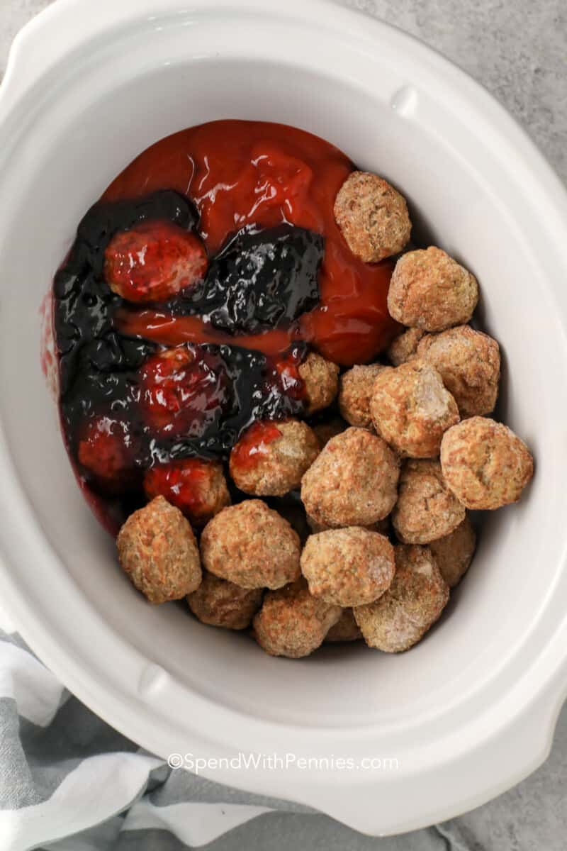 grape jelly meatball ingredients in a white slow cooker