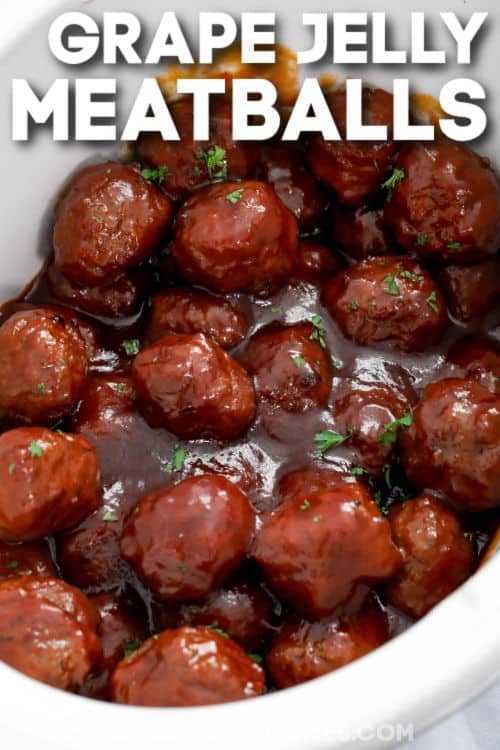crockpot full of cooked Grape Jelly Meatballs with a title