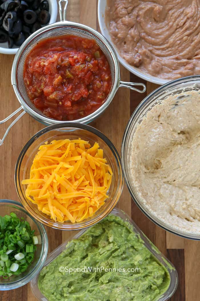 Ingredients for 7 Layer Dip on a wooden board